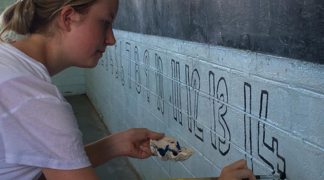 A Projects Abroad Care volunteer paints a classroom in Samoa A Care volunteer in Samoa revitalises a classroom by painting numbers